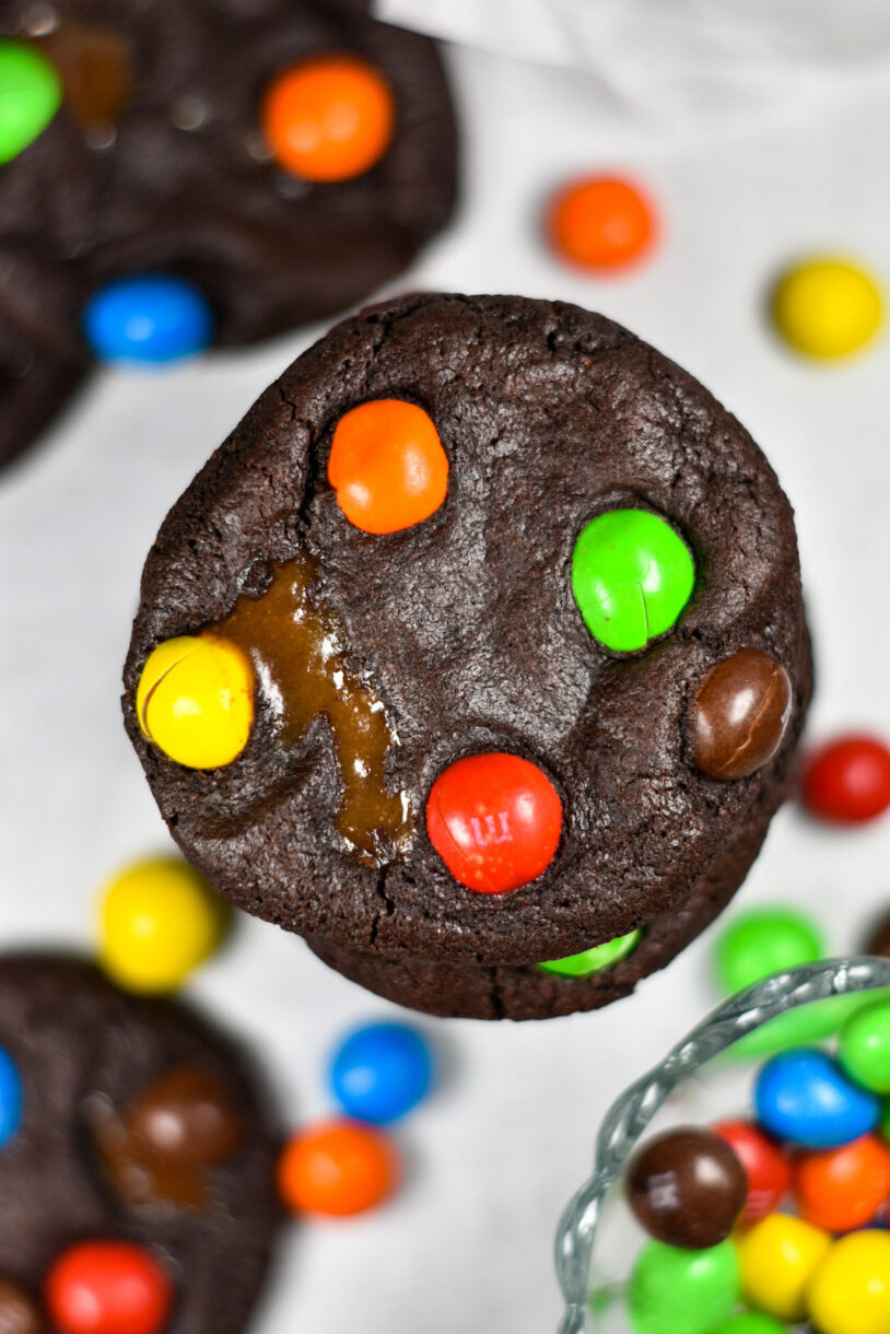 Caramel M&M Cookies on a white surface