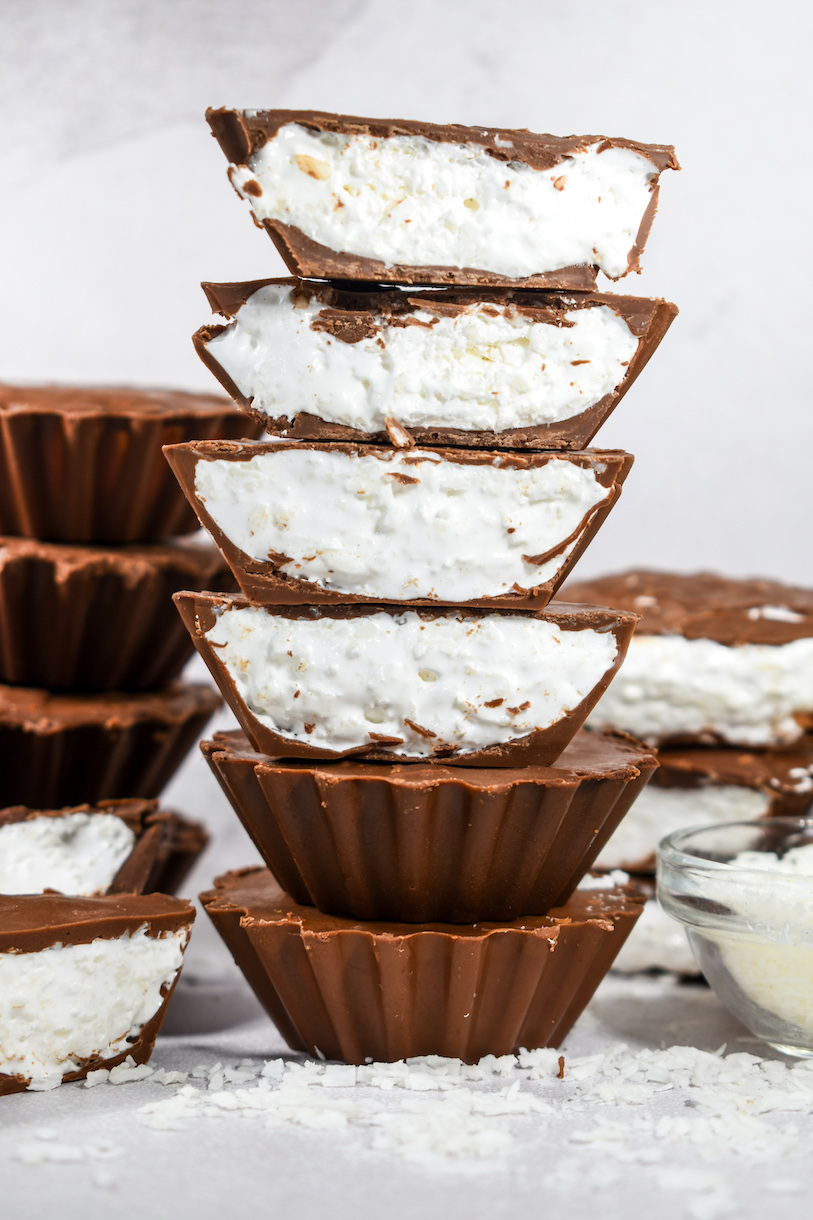 A stack of marshmallow chocolate cups on a white surface