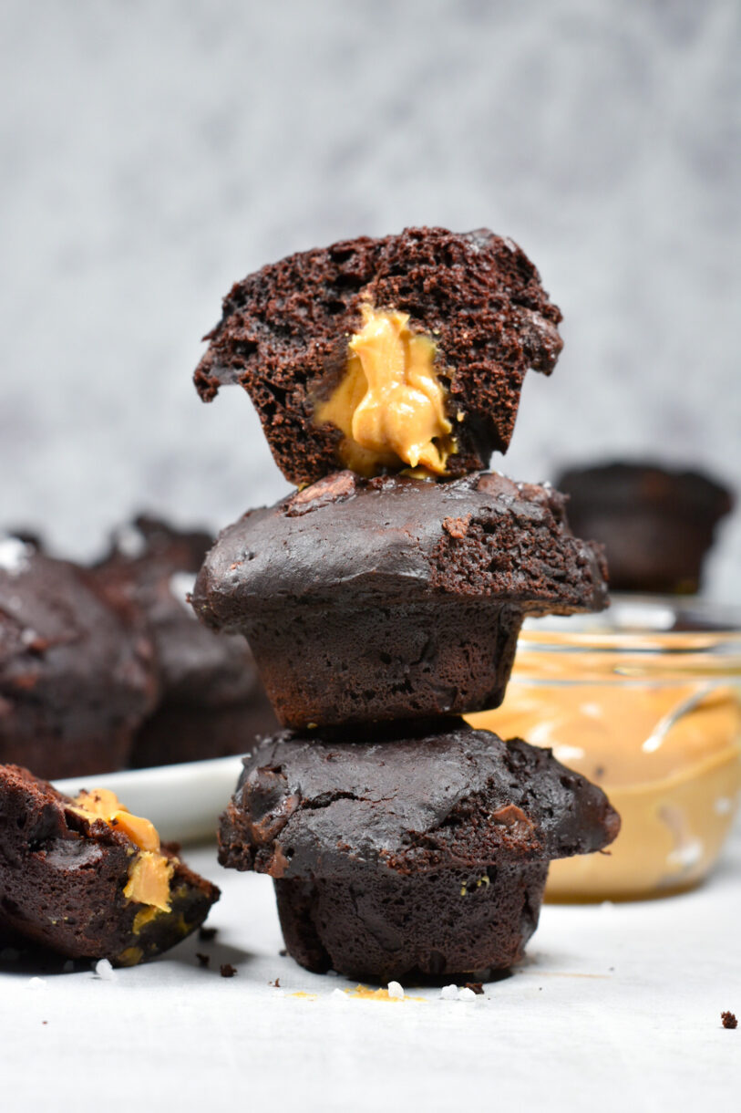 A stack of three chocolate peanut butter muffins