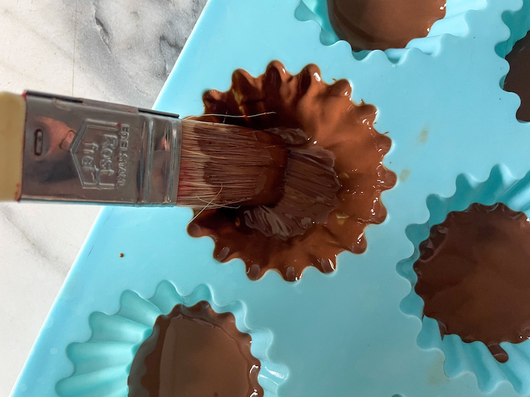 Brushing chocolate into a silicone mould