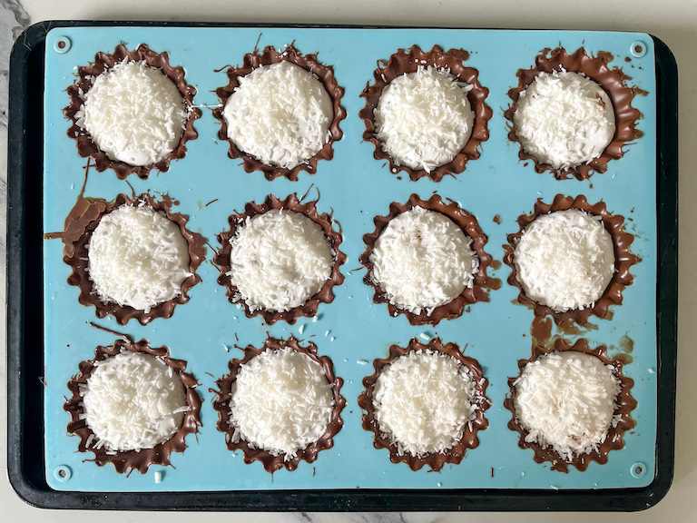 Chocolate cups in a mould with marshmallow and coconut