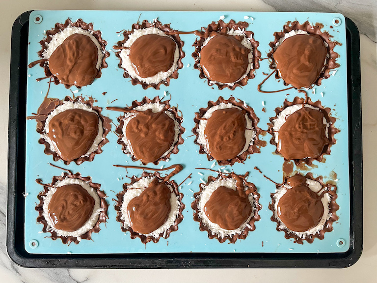 Tray of homemade mallo cups with melted chocolate on top