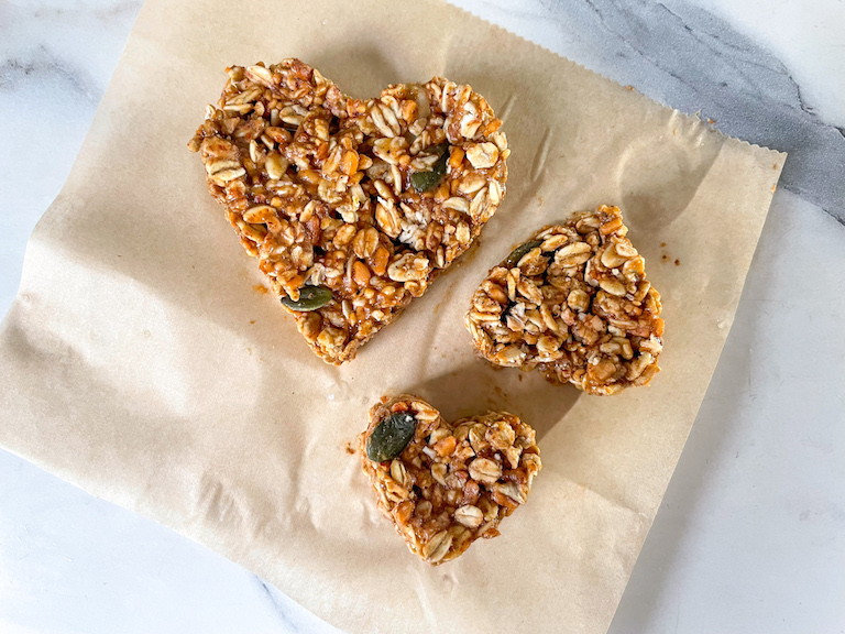 Granola hearts on a square of parchment