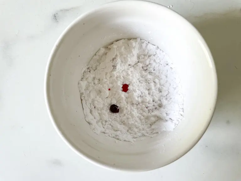 Bowl of confectioner's sugar with food coloring