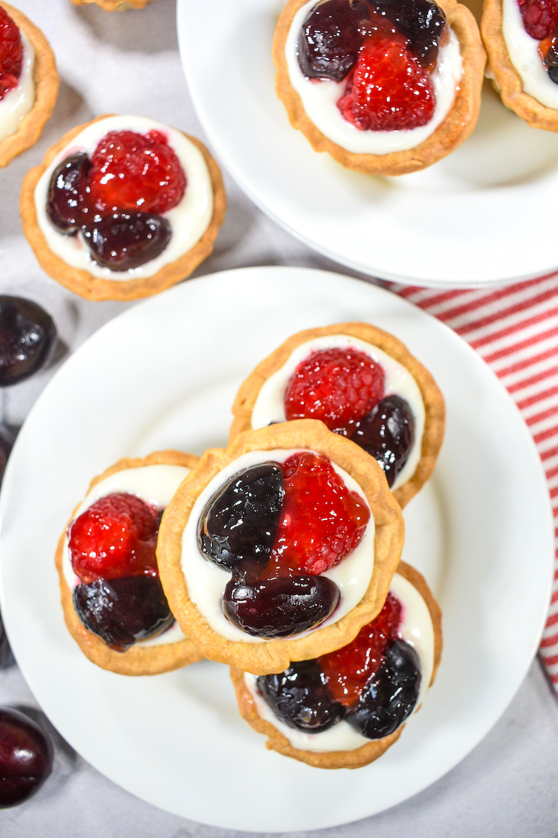 Stack of berry tarts arranged on a white plate