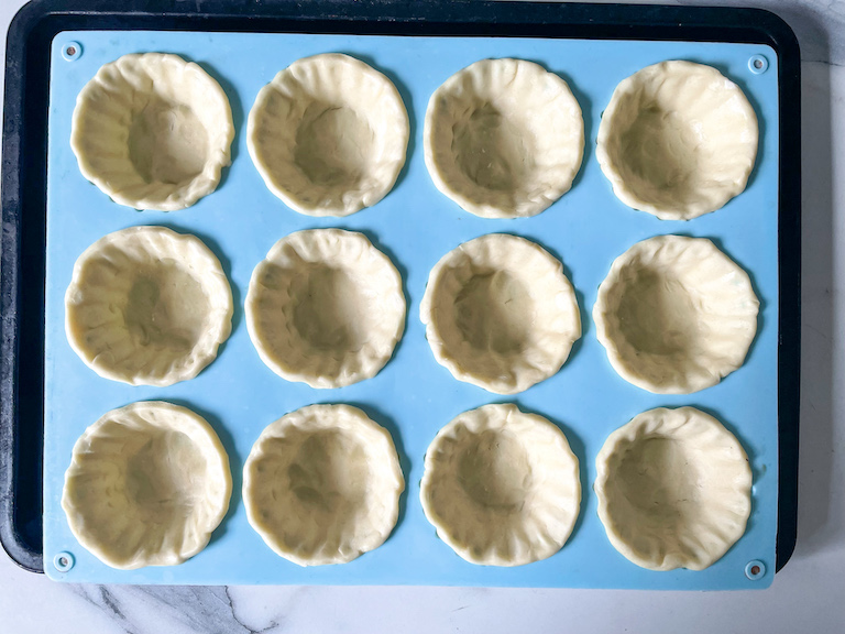 Shortcrust pastry pressed into tartlet mould