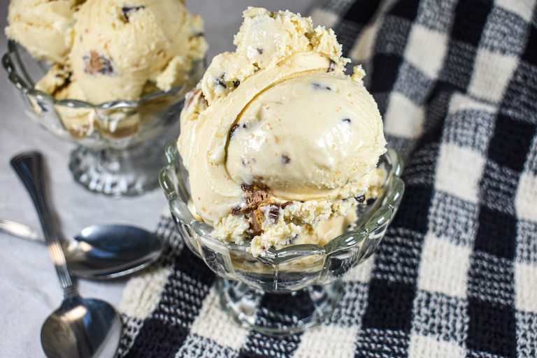 Dishes of peanut butter ice cream and a checkered tea towel