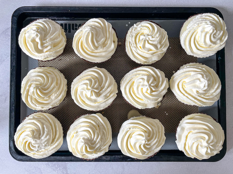Ice cream cupcakes piped with whipped cream