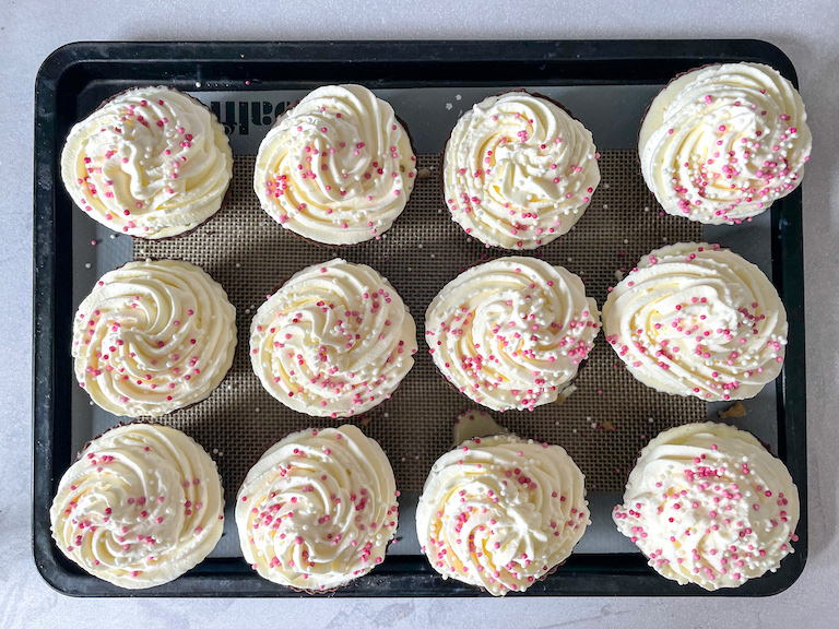 Ice cream cupcakes with whipped cream and pink sprinkles