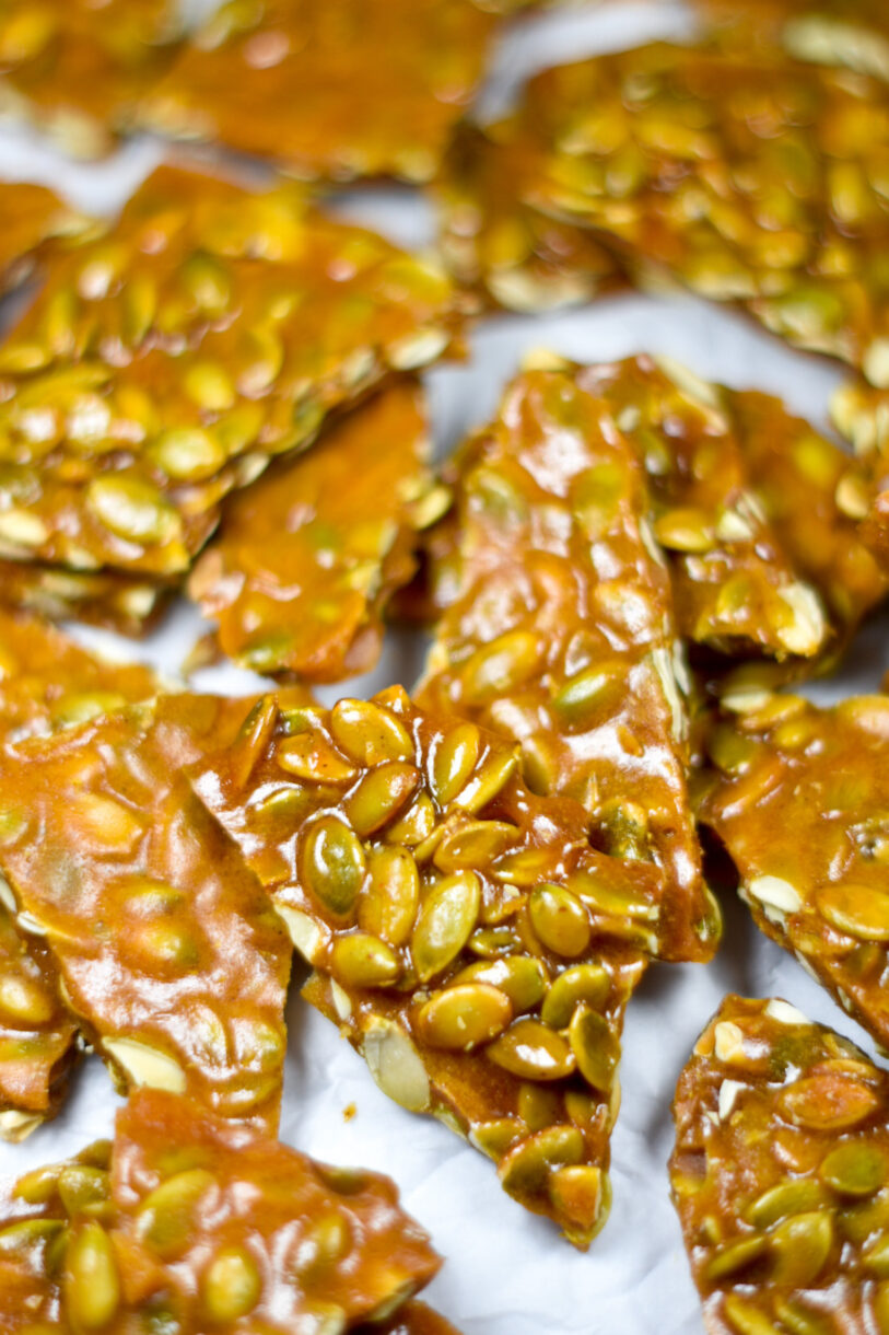 Spiced Pumpkin Seed Brittle on a white surface