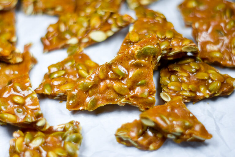 Spiced Pumpkin Seed Brittle on white surface