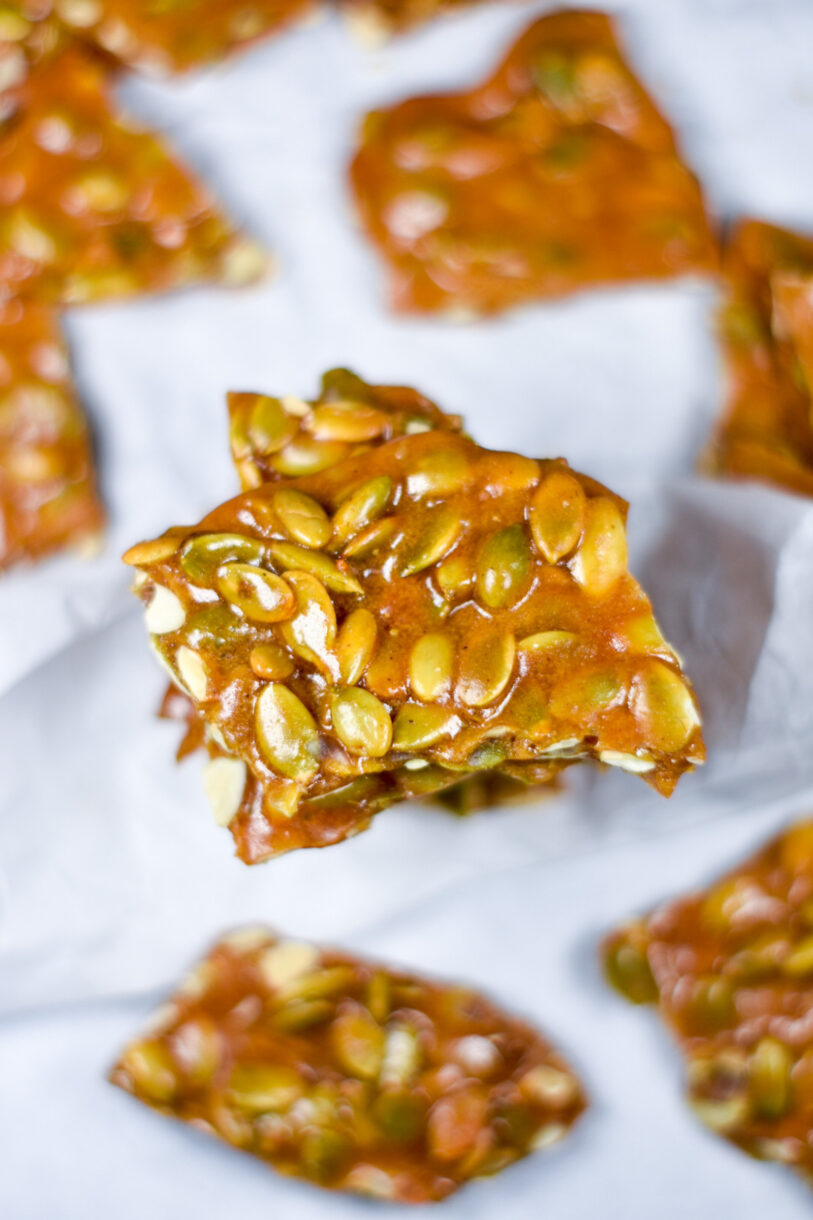 Spiced Pumpkin Seed Brittle on a white surface