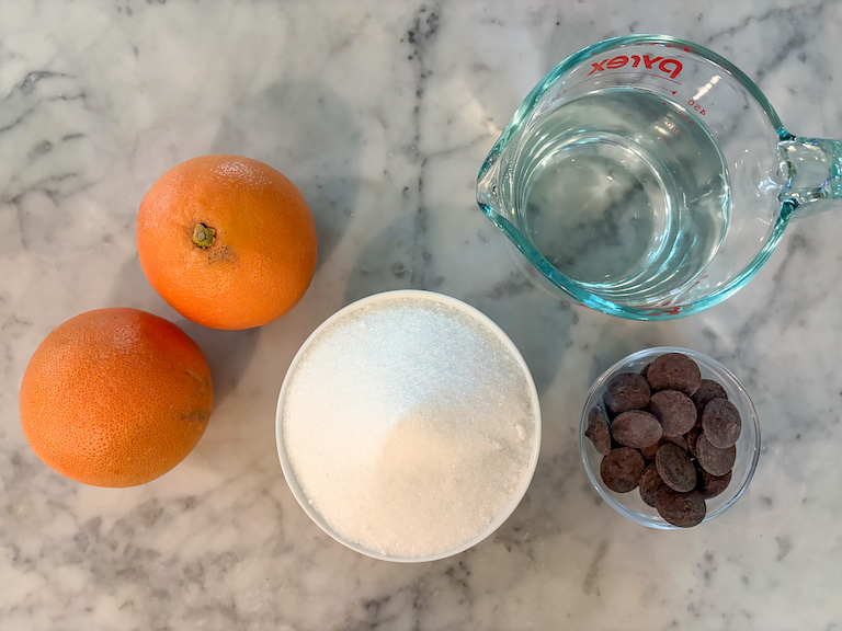 Candied grapefruit peel ingredients on a marble surface