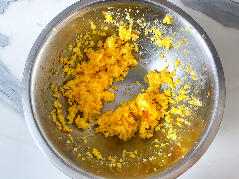 Butter in a bowl with orange juice, zest, and oil