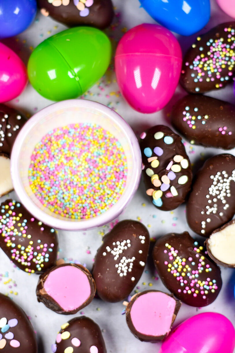 Buttercream Easter Eggs and plastic eggs with a bowl of sprinkles