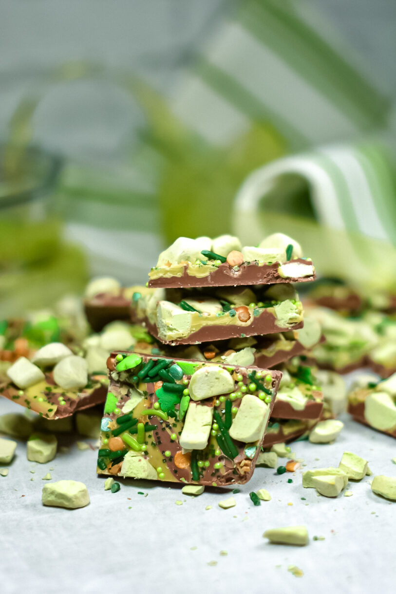 Chocolate bark in a stack, with green tea towel in background