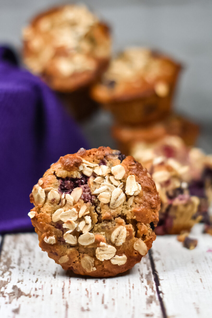 Front view of an oat and cornmeal muffin with berries