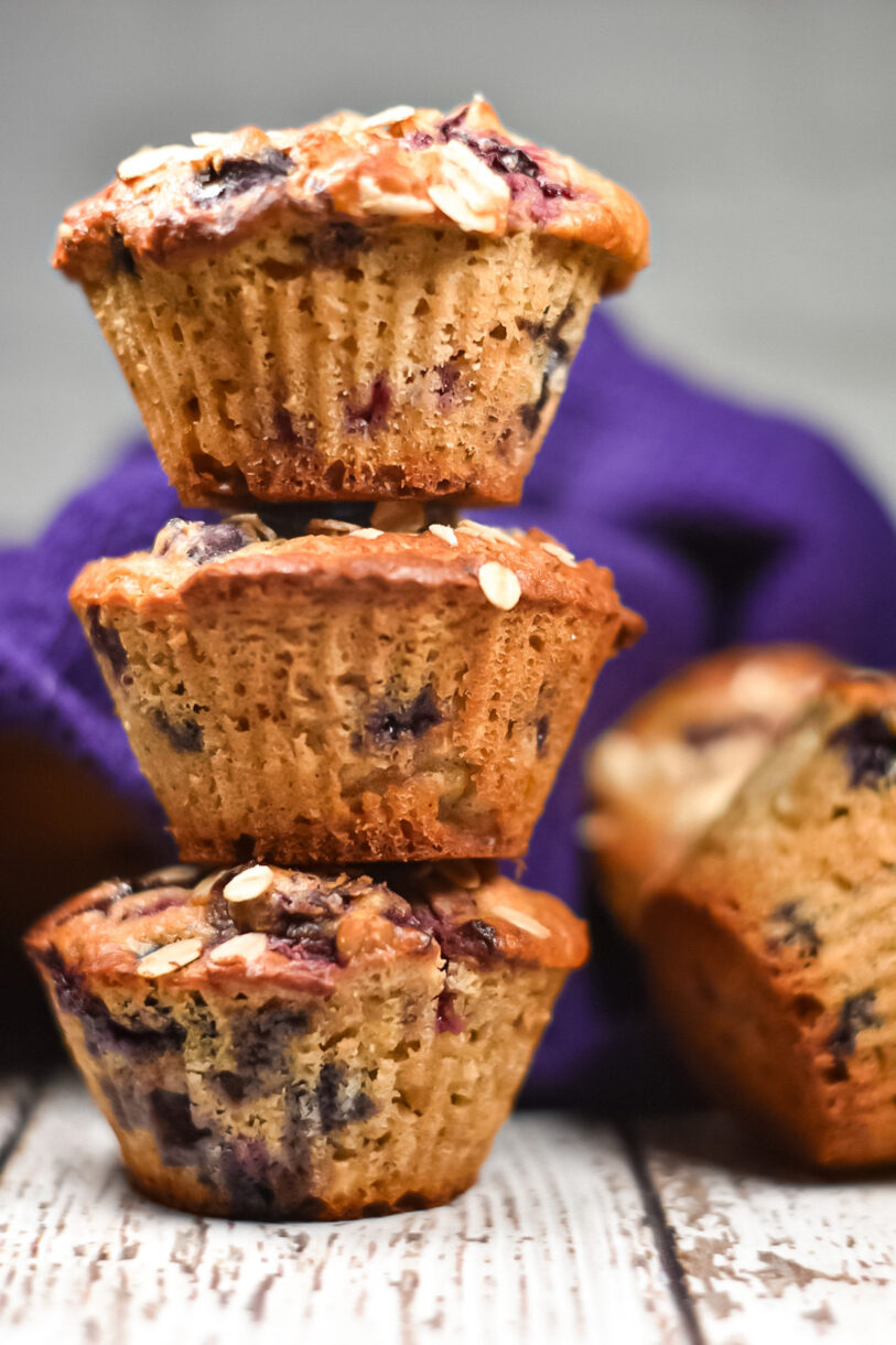 Stack of berry oatmeal cornmeal muffins