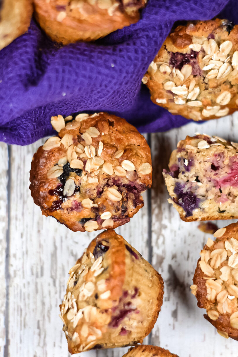 Berry muffins with oatmeal and a purple tea towel