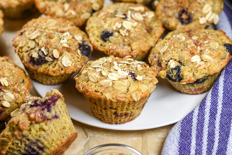 Oatmeal cornmeal muffins with fresh berries, arranged on a plate