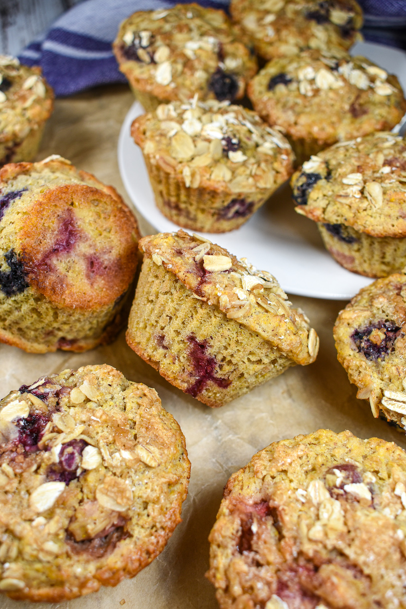 mixed berry muffins on a sheet of parchment