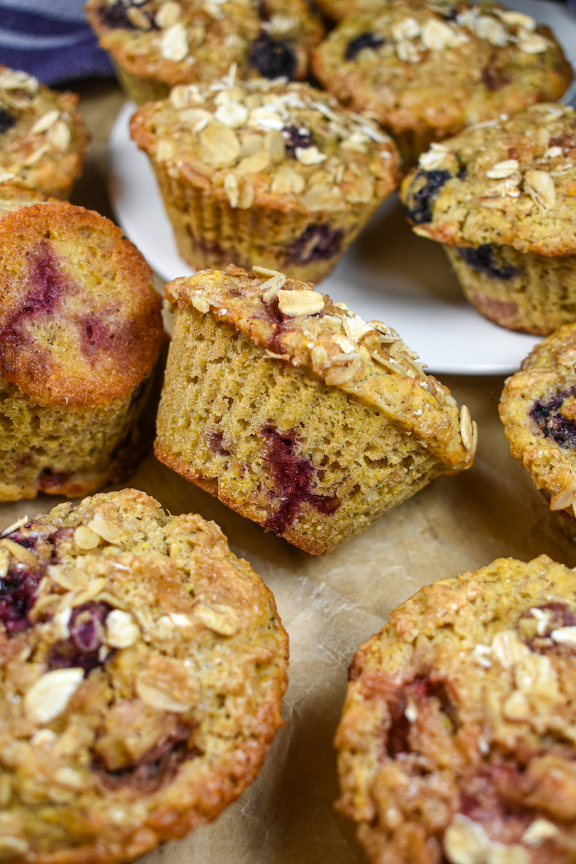 berry and oat muffins on a sheet of parchment