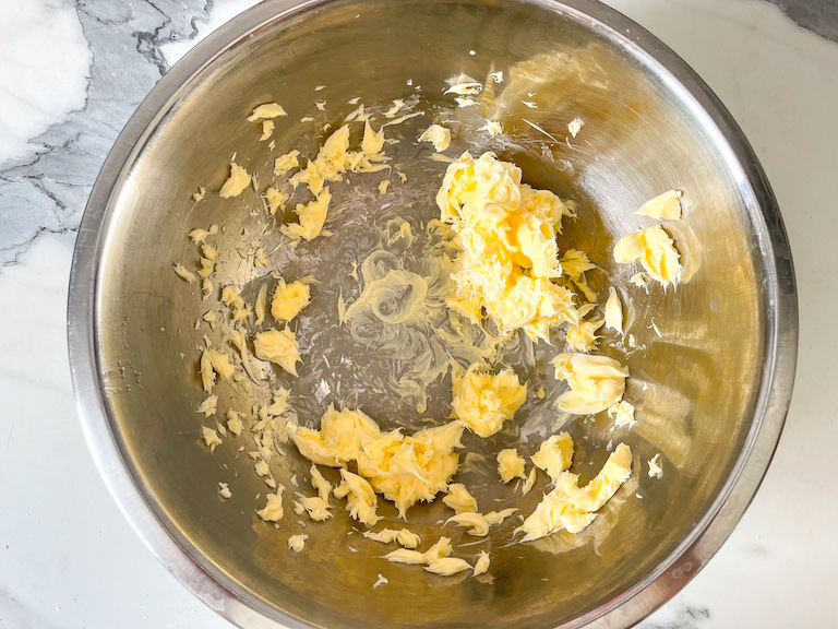 Butter in a metal mixing bowl