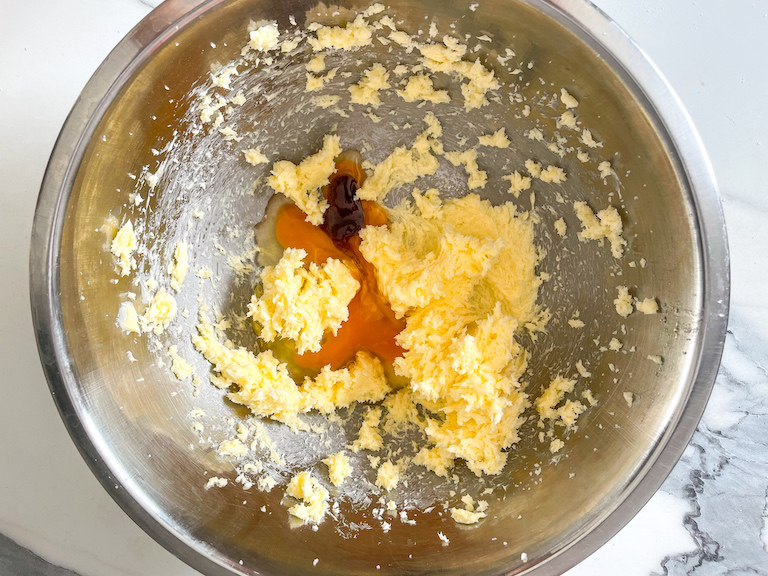 Butter, eggs, and vanilla in a mixing bowl