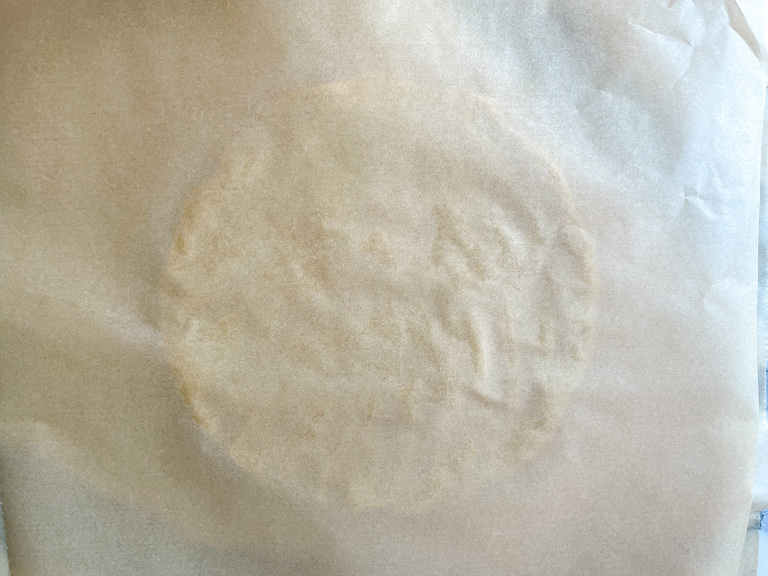 Sheets of parchment with cookie dough in between