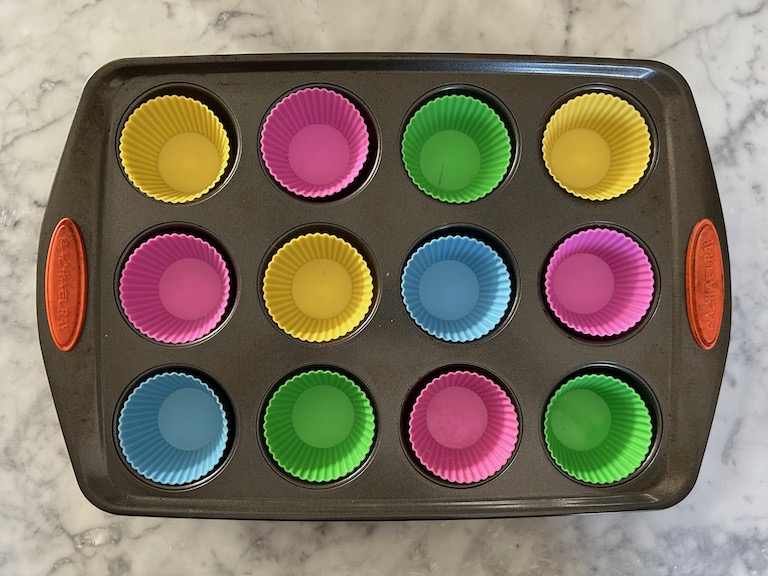 a muffin tin lined with silicone liners