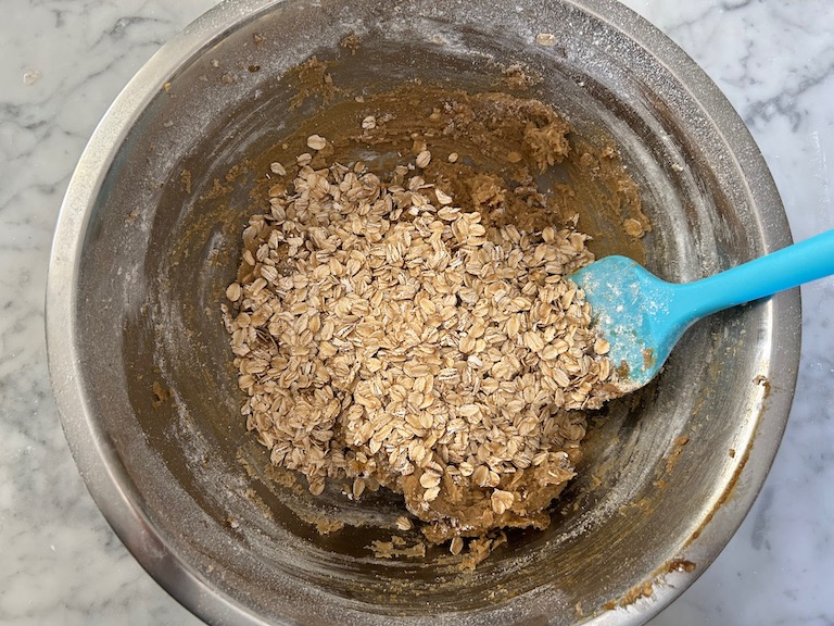 Stirring oats into cookie dough