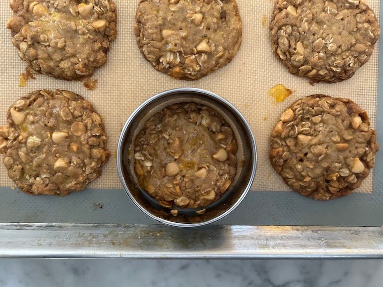 Cutter reshaping an oatmeal butterscotch cookie