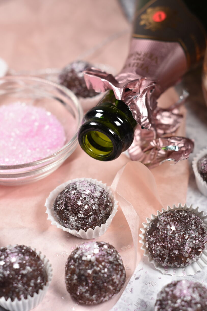Sparkling Rose Truffles, bowl of sugar, open bottle, and pink tissue paper