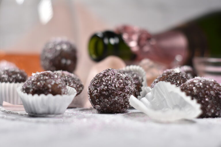 truffles and white paper truffle cups on a white surface