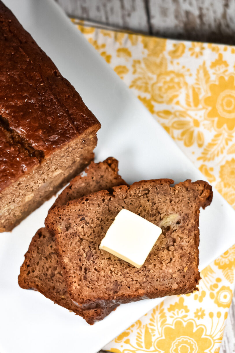 Chai spiced banana bread slice with a pat of butter on top