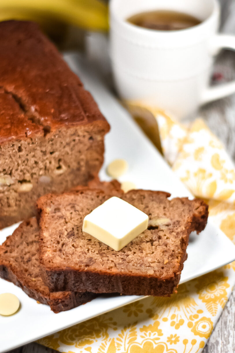 Chai spiced banana bread and slices with pat of butter