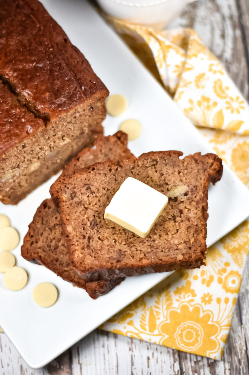 A loaf of chai spiced banana bread and slice with butter