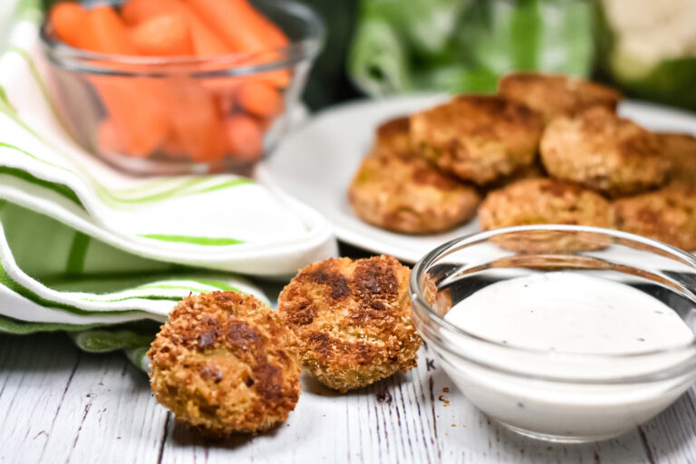 Baked vegetarian vegetable nuggets, a bowl of carrots, and bowl of ranch dressing