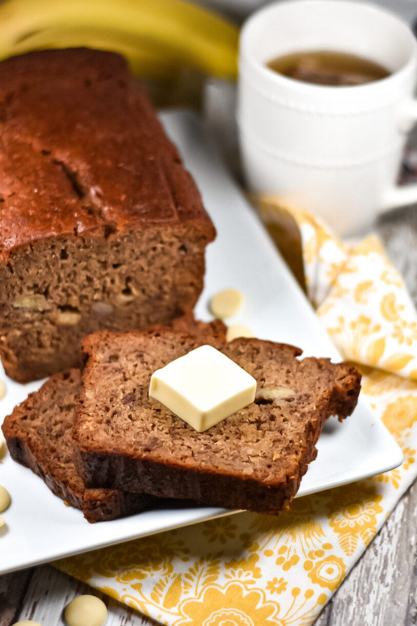 Chai spiced banana bread and slices with pat of butter