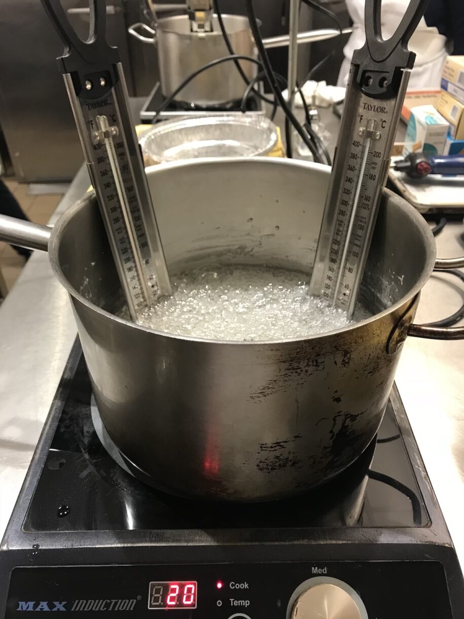 Pot of boiling isomalt with two thermometers
