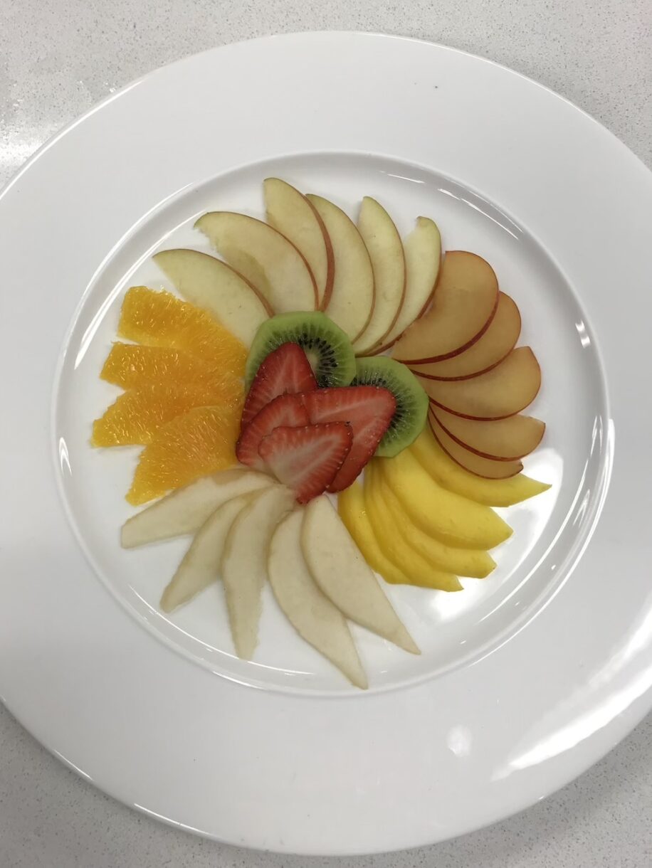 Fruit slices arranged on a white plate
