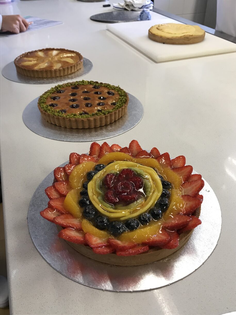 Almond and fruit tarts on marble countertop
