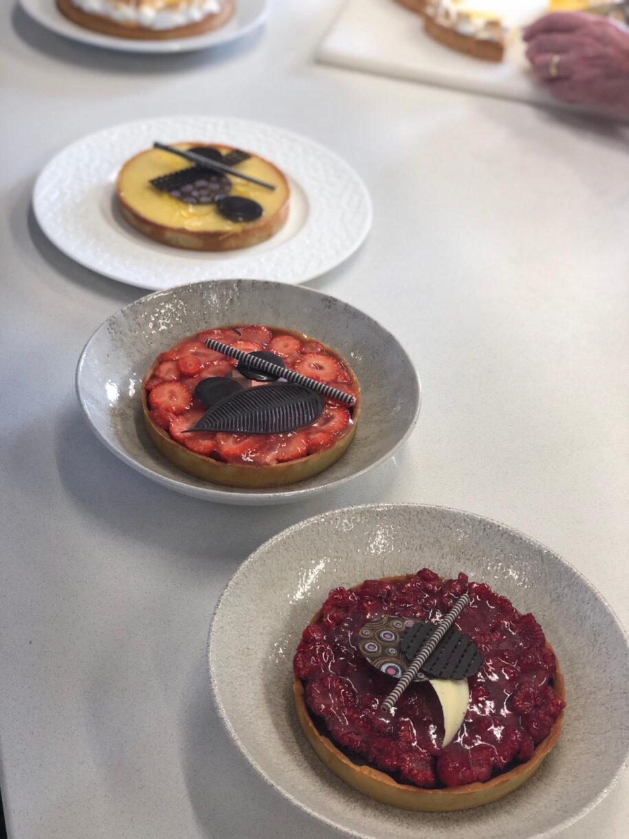 Assorted tarts arranged on a white countertop