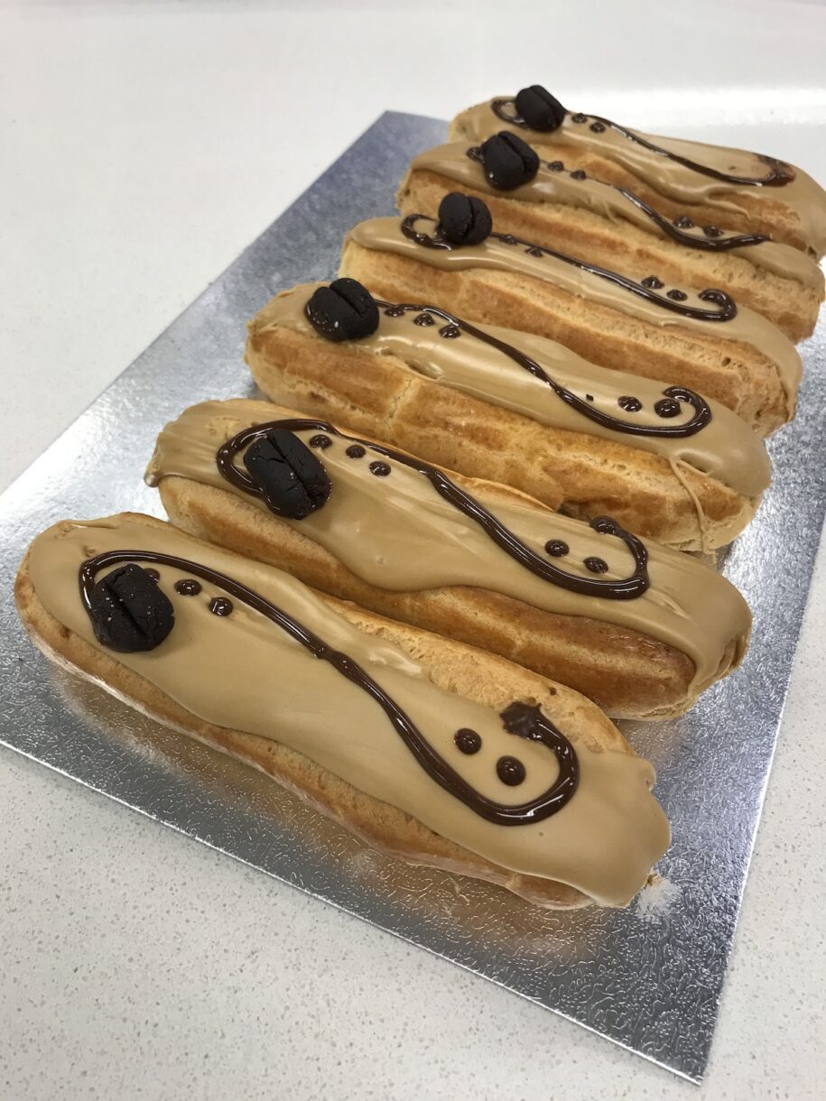 Eclairs au café with chocolate piping