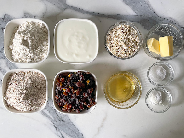Ingredients for making a soda bread recipe, arranged on a marble countertop