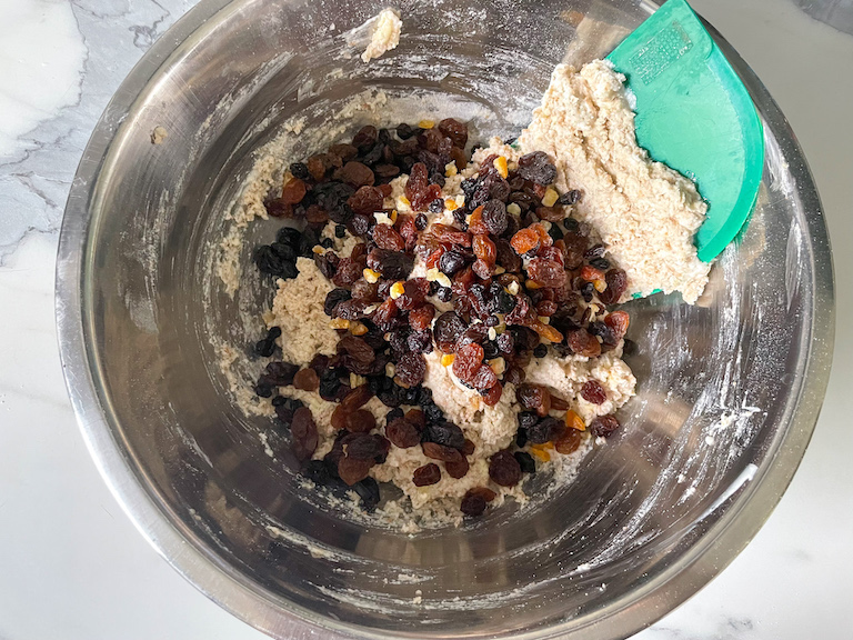 Bench Scraper and mixed dried fruit in a bowl with soda bread dough