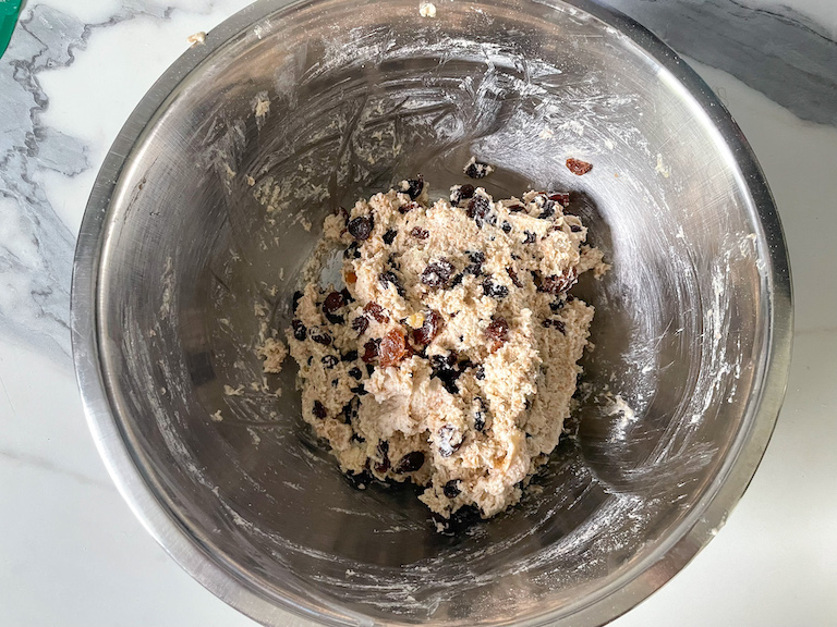 Soda bread dough in bowl with mixed dried fruit