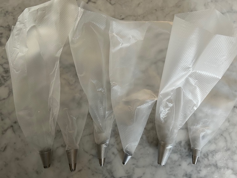 Disposable piping bags fitted with metal tips