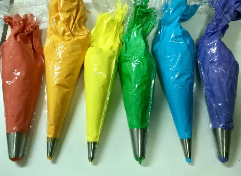 Rainbow meringue in piping bags
