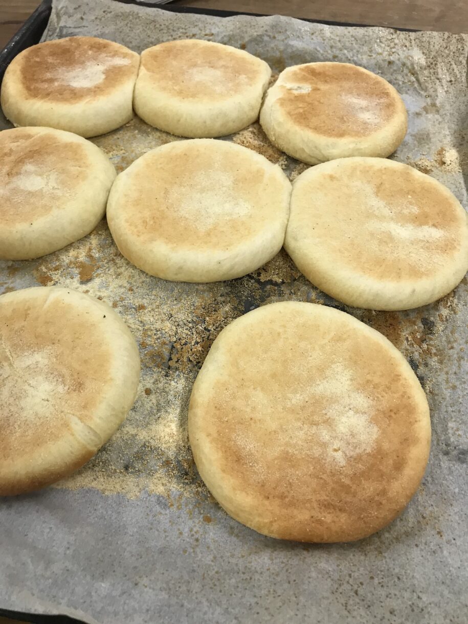 Fresh-baked English muffins dusted with semolina